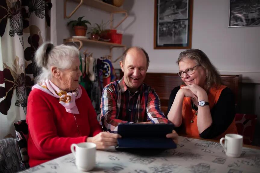 People using a tablet device.