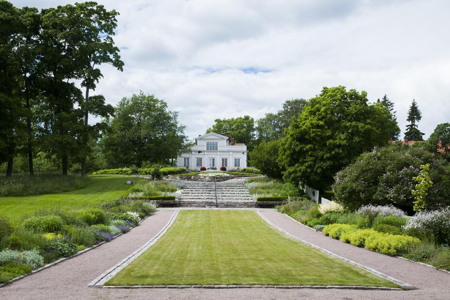 Annala Villa Park’s perennial plantings with Villa Annala in the background.