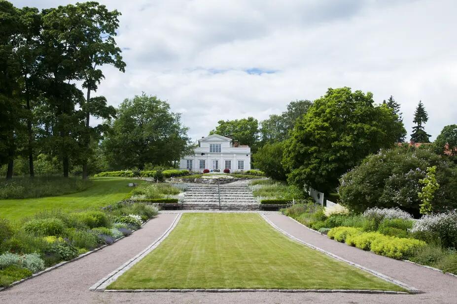 Annala Villa Park’s perennial plantings with Villa Annala in the background.